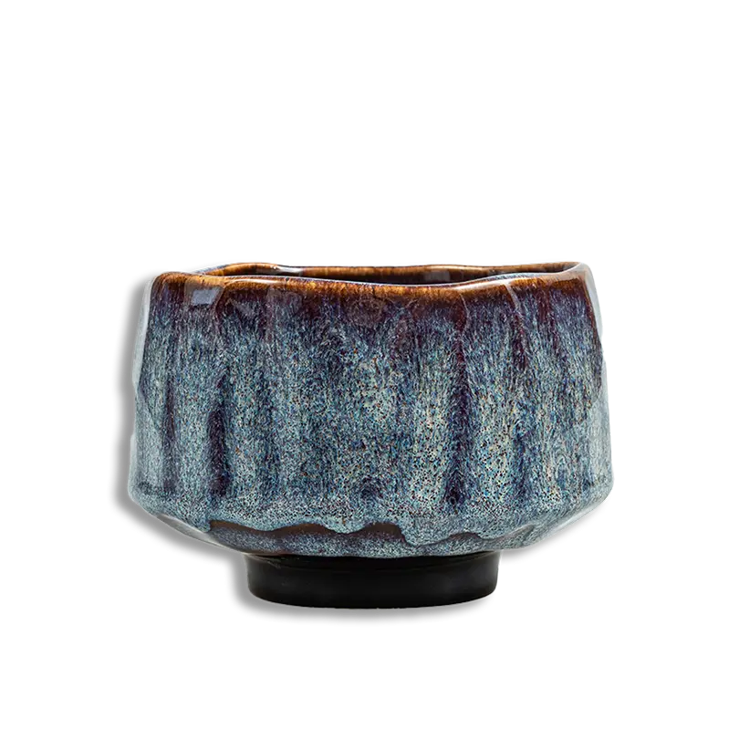 Ceramic cup with textured surface on a white background