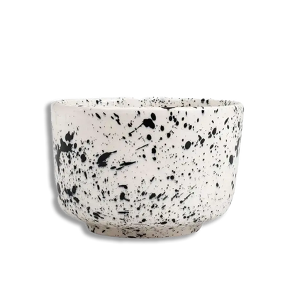 Speckled ceramic bowl on a white background