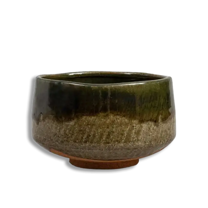 Green ceramic pot on a white background