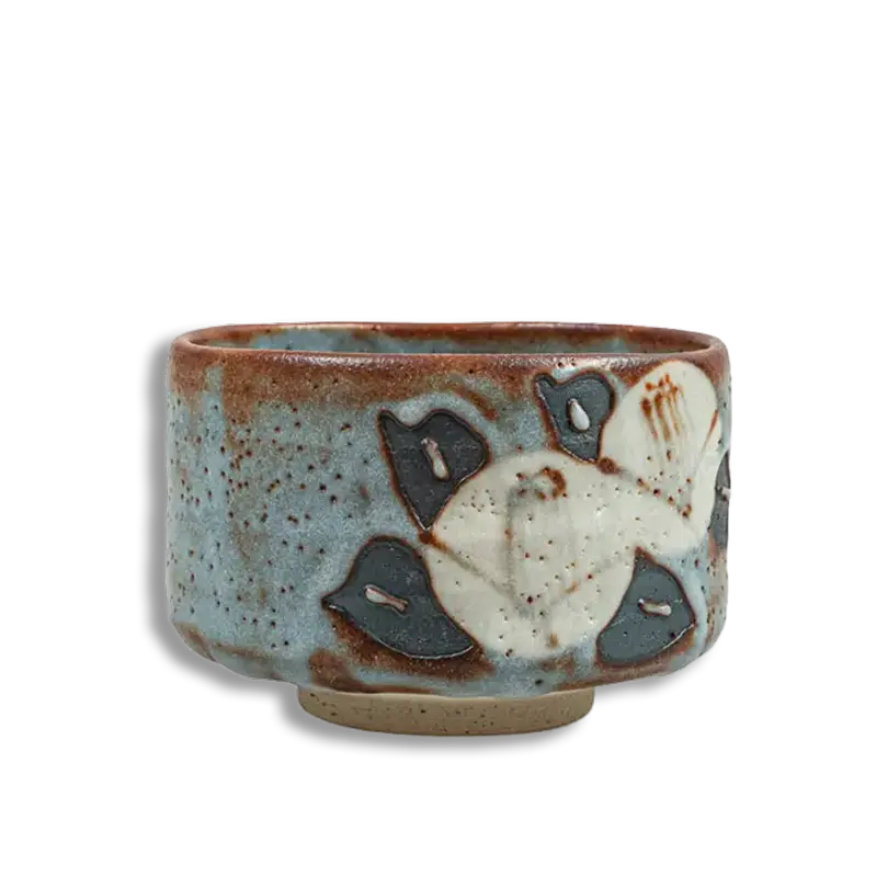 Ceramic cup with floral design on a white background
