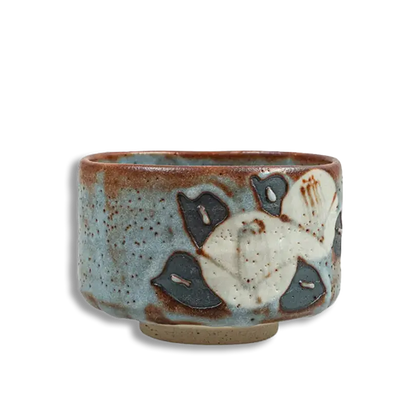 Ceramic cup with floral design on a white background