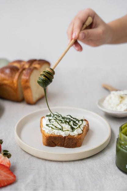 Organic honey infused with Moya matcha for a sweet, earthy spread or natural sweetener