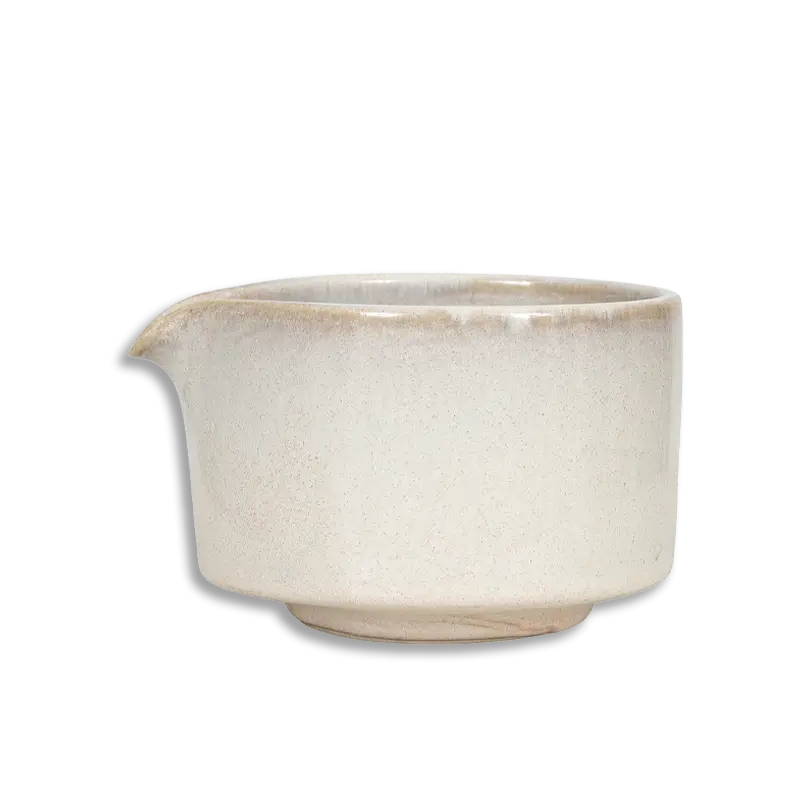 Beige ceramic pitcher on a white background