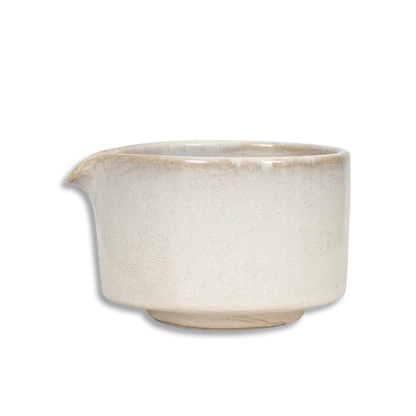 Beige ceramic pitcher on a white background