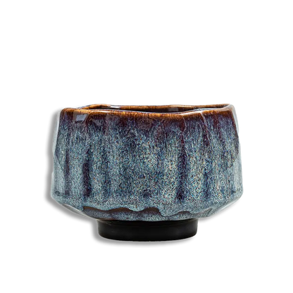 Ceramic cup with textured surface on a white background