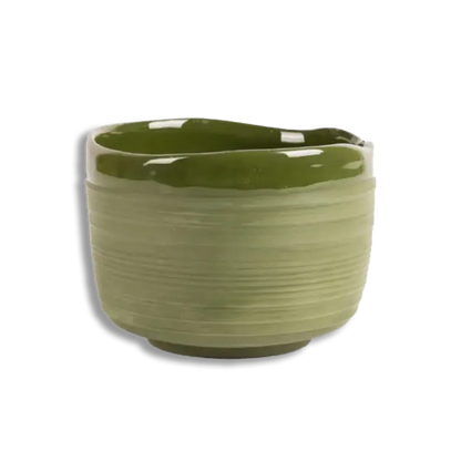 Green ceramic planter on a white background