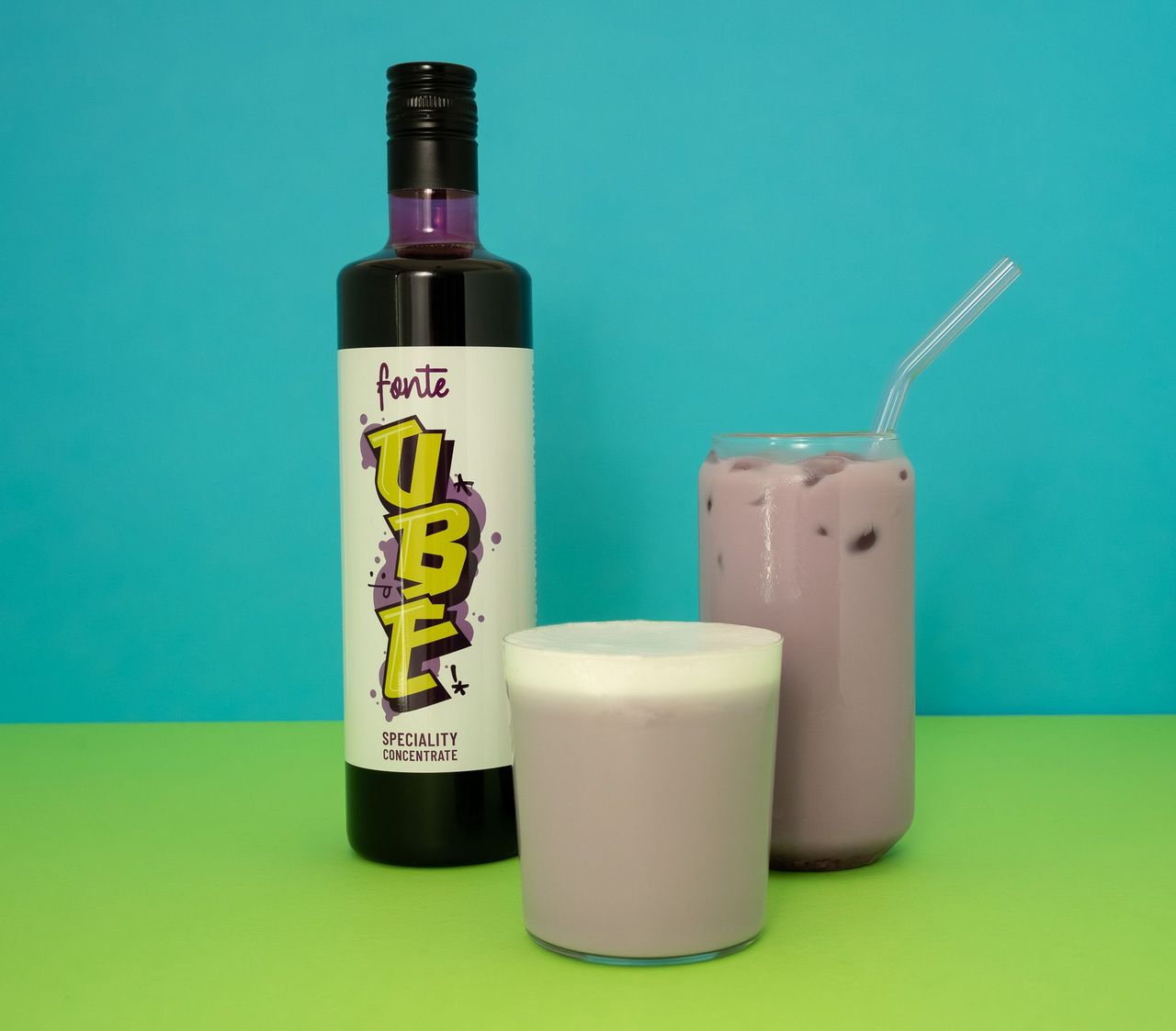 Bottle of 'fonte TUBE' concentrate with two glasses of a purple drink on a green and blue gradient background.